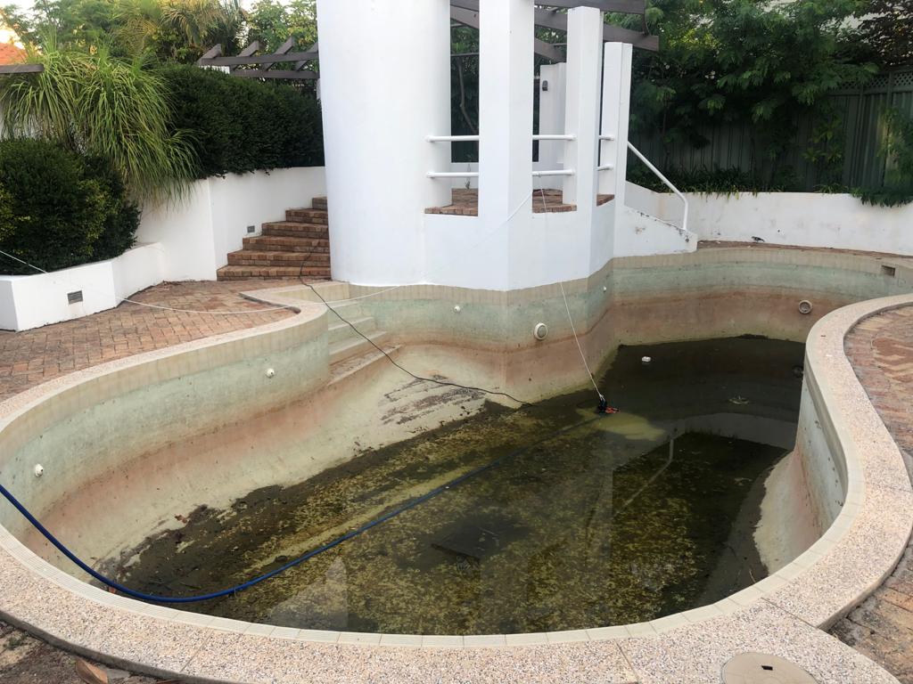 Neglected Sydney swimming pool drained before cleaning and restoration