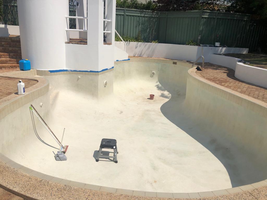 Empty swimming pool after cleaning and surface preparation before painting